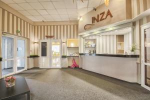a lobby with a naa sign on the wall at Inza Hotel in Druskininkai