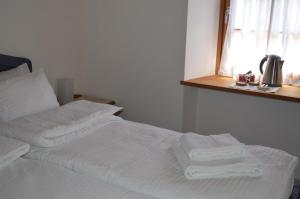 a white bed with towels on it in a room at B&B Arlanch 8 in Vallarsa
