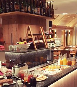 a buffet line with plates of food in a restaurant at Hotel Botteltje in Ostend