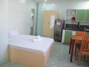 a small room with a bed and a kitchen at Cool Stay Inn in Boracay