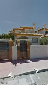 a large house with a fence in front of it at Ric Rent in Rojales