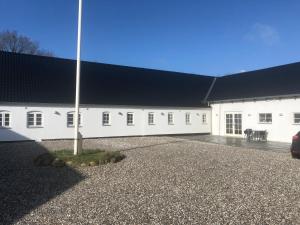 a large white building with a black roof at B & B Gødstrup - cafe og restaurant Den Gamle Stald in Herning