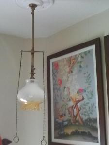 a light hanging from a ceiling with a picture at The Iverna in Eastbourne