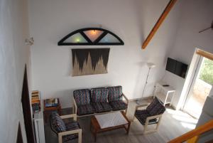 a living room with two chairs and a table at Beaufort apartment in Stoupa