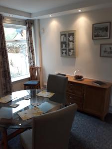 a dining room with a table and chairs and a desk at Lincoln lets 23 in Lincoln
