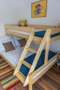 A bed or beds in a room at Servus Vendégház