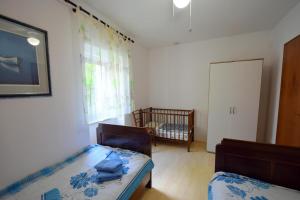 Postel nebo postele na pokoji v ubytování Apartments Neven