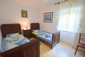 Postel nebo postele na pokoji v ubytování Apartments Neven