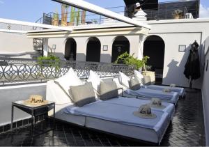 a row of beds sitting on a balcony at Riad Dar Bahi in Marrakesh