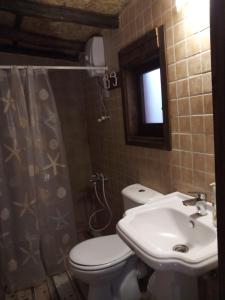 a bathroom with a toilet and a sink at Mystery Garden Guest House in Famagusta