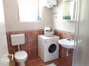 a bathroom with a washing machine and a sink at Apartments Kule in Brela +56 photos