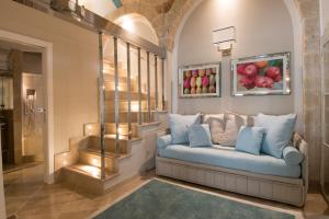 a living room with a couch and a painting of apples at Hotel Don Ferrante in Monopoli