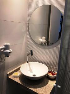 a bathroom with a sink and a mirror at Pousada Atoba in Fernando de Noronha