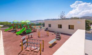 a playground with slides and a play structure at Mellieha Holiday Centre in Mellieħa