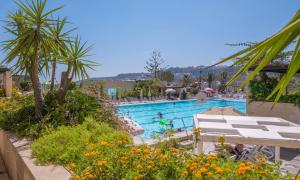 a pool at a resort with people swimming in it at Mellieha Holiday Centre in Mellieħa