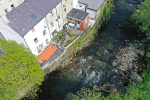 an aerial view of a house next to a river at Glanafon Cottage in Bethesda +9 photos
