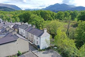 an aerial view of a house with mountains in the background at Glanafon Cottage in Bethesda