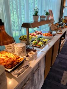 a buffet line with many different types of food at Express Kraków Hotel in Krakow