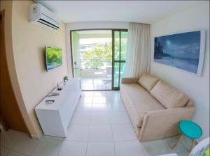 a living room with a couch and a table at Flats no Carneiros Beach Resort in Tamandaré