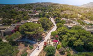 an aerial view of a city with houses and trees at Mellieha Holiday Centre in Mellieħa