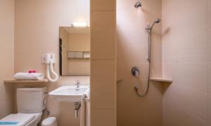 a bathroom with a shower and a toilet and a sink at Mellieha Holiday Centre in Mellieħa
