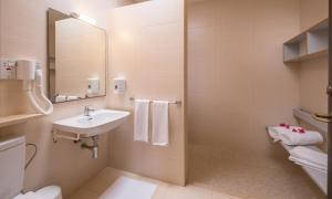 a bathroom with a sink and a toilet and a mirror at Mellieha Holiday Centre in Mellieħa