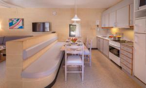 a small kitchen with a table and a counter top at Mellieha Holiday Centre in Mellieħa
