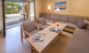 a living room with a couch and a table at Mellieha Holiday Centre in Mellieħa