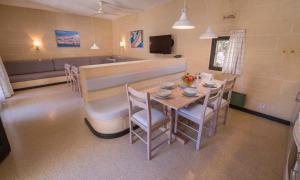 a dining room with a table and chairs at Mellieha Holiday Centre in Mellieħa