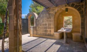 a stone building with a table on a patio at Mellieha Holiday Centre in Mellieħa