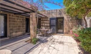 a patio with a table and chairs on it at Mellieha Holiday Centre in Mellieħa
