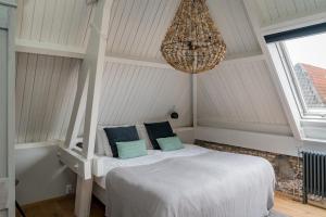 Tempat tidur dalam kamar di De Verwennerie