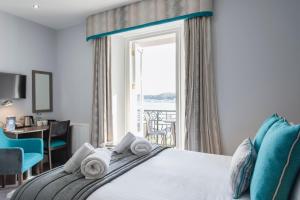 a bedroom with a bed with a view of the ocean at Belmont Llandudno in Llandudno