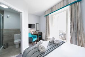 a bedroom with a bed with towels on it at Belmont Llandudno in Llandudno