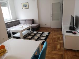 a living room with a couch and a table at Apartman Gaga in Lukavica