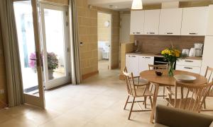 a kitchen and dining room with a table and chairs at Mellieha Holiday Centre in Mellieħa