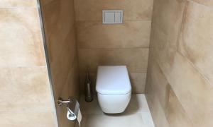 a bathroom with a white toilet in a stall at Mellieha Holiday Centre in Mellieħa
