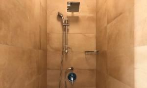 a shower with a shower head in a bathroom at Mellieha Holiday Centre in Mellieħa