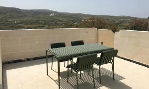 a table and chairs on top of a roof at Mellieha Holiday Centre in Mellieħa