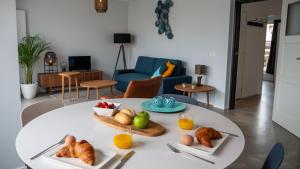 a white table with plates of food on it at Appartementen De Boulevard in Zandvoort