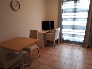 a room with a table and a desk with a television at Domaine de l'Albatros in Mouans-Sartoux