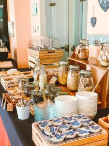 a buffet with plates and jars of food on a table at Hotel Bonadies in Ravello