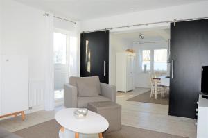 un salon avec une chaise et une table dans l'établissement Villa Herbstwind in Binz, à Binz
