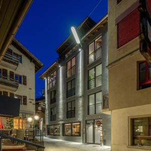 a rendering of a building at night at Hotel Heimatlodge in Sankt Niklaus