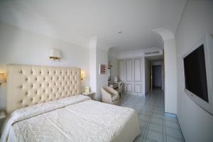 a bedroom with a bed and a flat screen tv at Hotel Villa Fraulo in Ravello