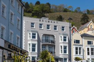 a white building with a sign that reads beaumont at Belmont Llandudno in Llandudno