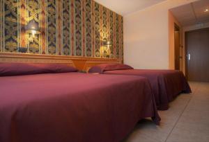 A bed or beds in a room at San Giovanni Rotondo Palace - Alihotels