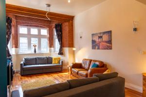 a living room with a couch and two chairs at Apartment No 1 - The Old Red King Pub, Whitefield, Manchester in Manchester