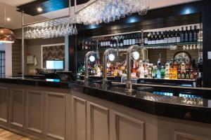 a bar at a restaurant with a counter with drinks at Belmont Llandudno in Llandudno