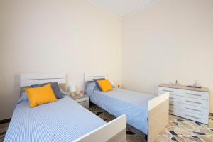 sypialnia z 2 łóżkami i komodą w obiekcie Casetta Vista Mare in Piazza a Mondello w mieście Palermo